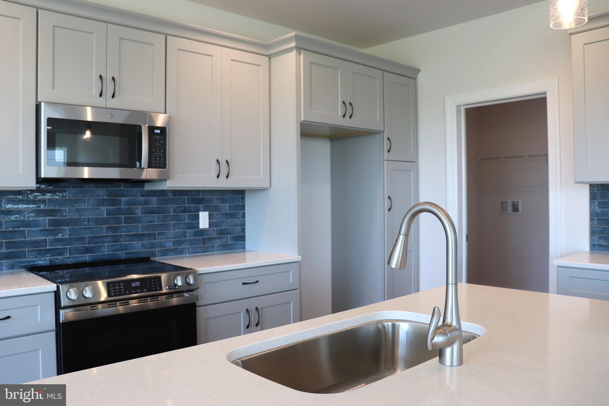 1029 Strafford Place, Unit 55 Lancaster, PA 17601 - Photo 10 of 40 a kitchen with stainless steel appliances granite countertop a sink stove and refrigerator