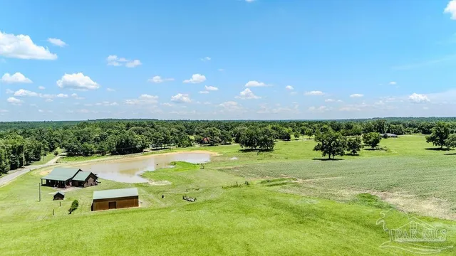 a view of a house with swimming pool and yard