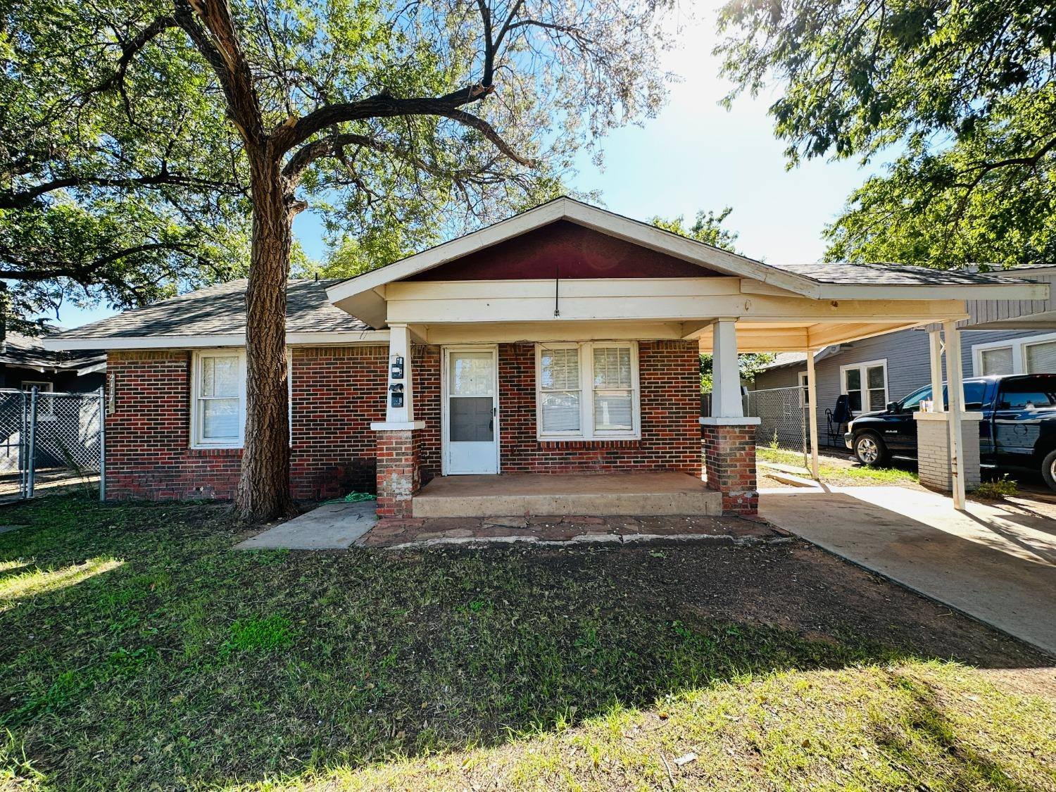 2117 15th Street, Unit A Lubbock, TX 79401 - Photo 1 of 11 a front view of a house with a yard and porch