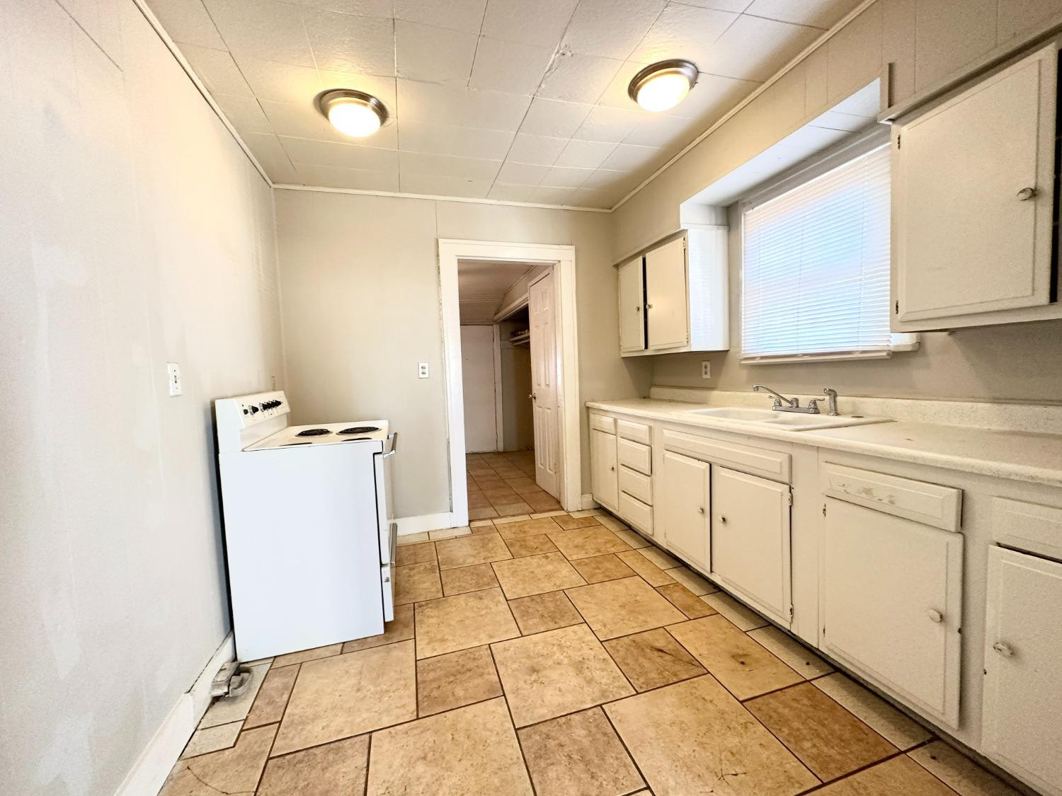 2117 15th Street, Unit A Lubbock, TX 79401 - Photo 4 of 11 a utility room with cabinets washer and dryer