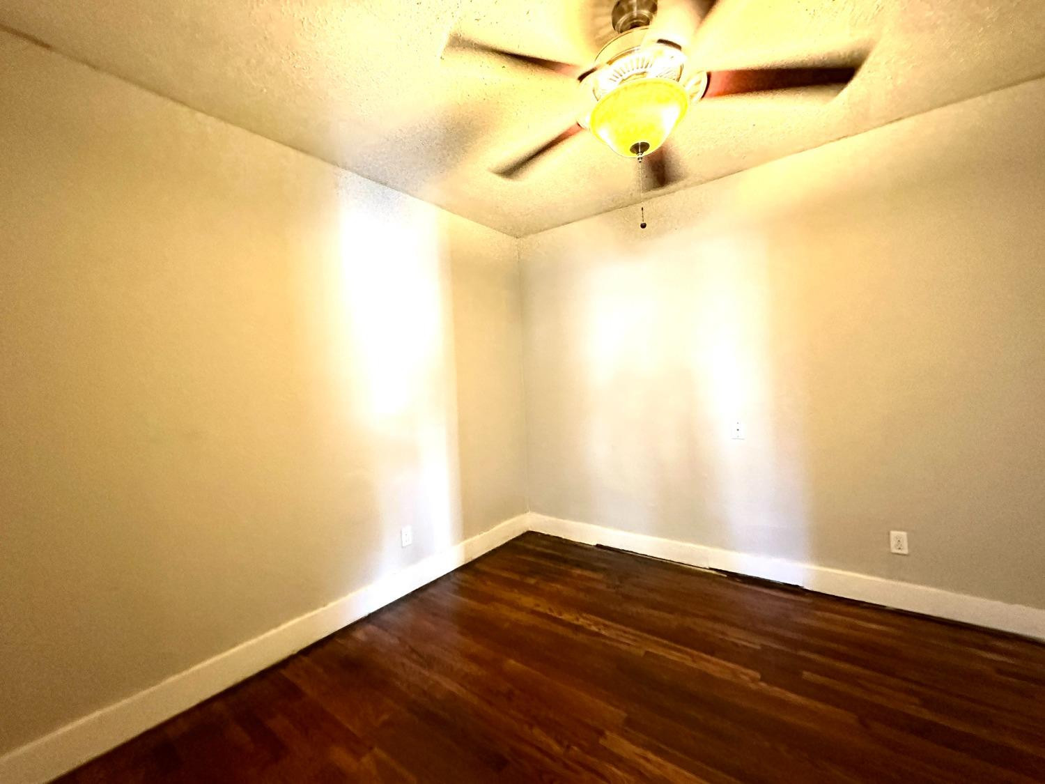 2117 15th Street, Unit A Lubbock, TX 79401 - Photo 5 of 11 a view of an empty room with wooden floor
