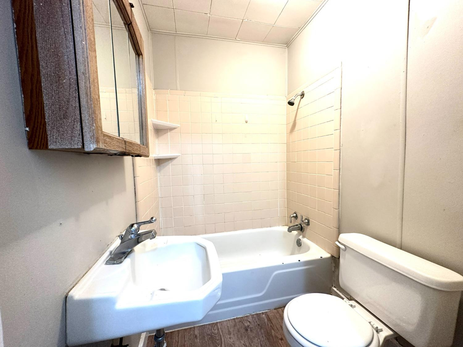 2117 15th Street, Unit A Lubbock, TX 79401 - Photo 7 of 11 a bathroom with a sink a toilet and bathtub