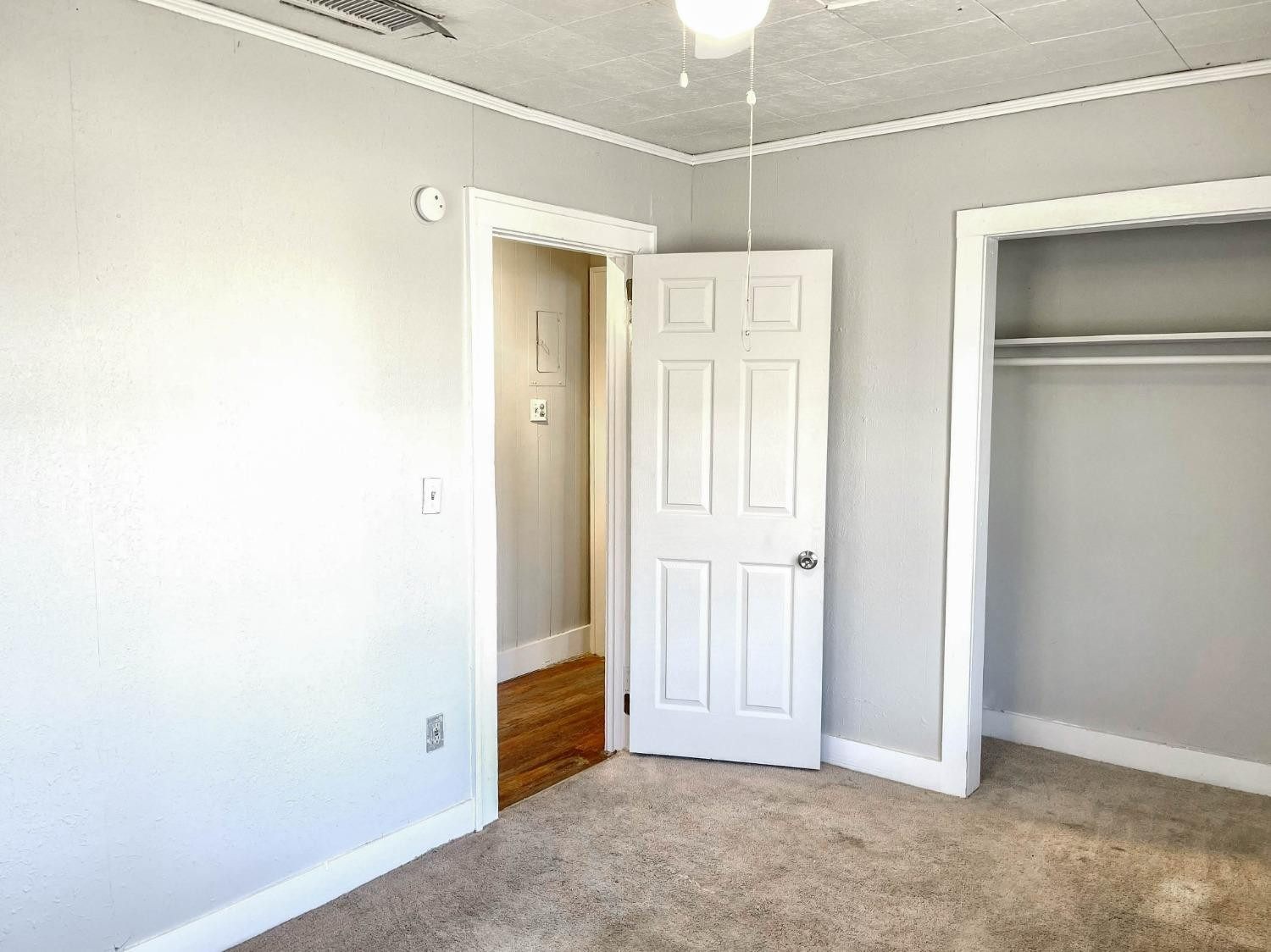 2117 15th Street, Unit A Lubbock, TX 79401 - Photo 10 of 11 an empty room with windows and closet
