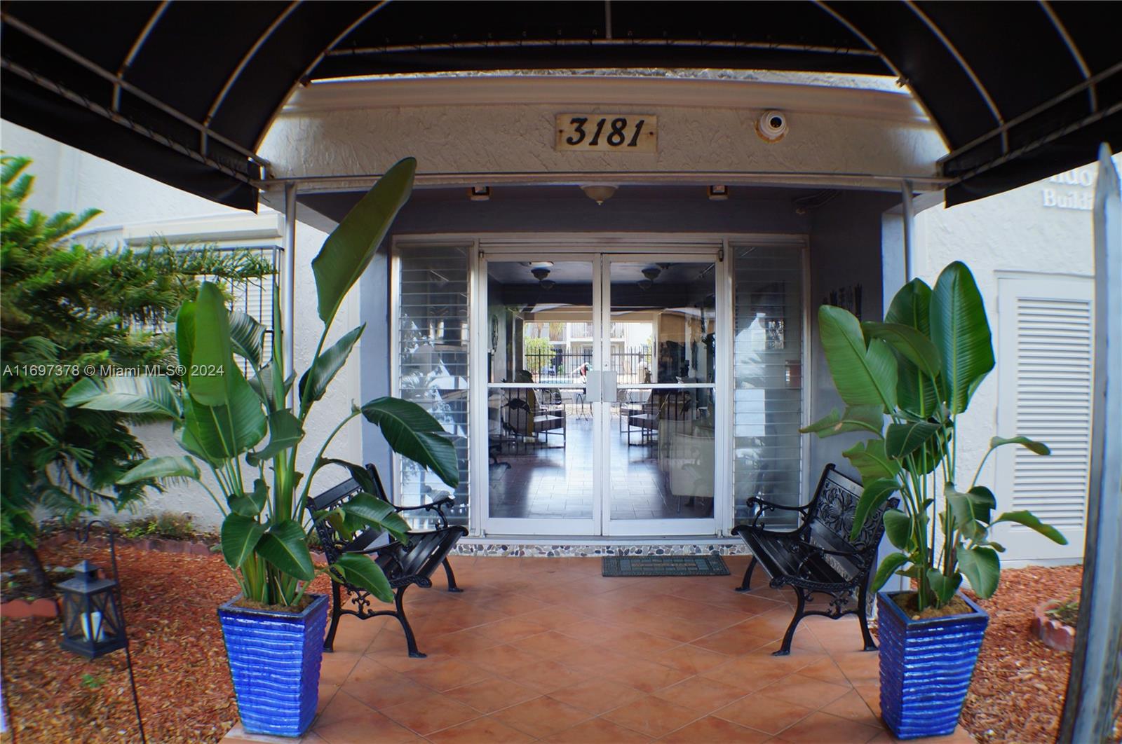 3181 Southwest 13th Street, Unit 111 Miami, FL 33145 - Photo 3 of 25 New awning provides shade to wait for your uber in comfort.