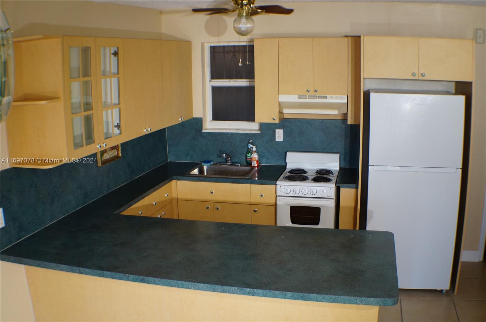 3181 Southwest 13th Street, Unit 111 Miami, FL 33145 - Photo 9 of 25 A warm and nice kitchen with plenty of counter space.