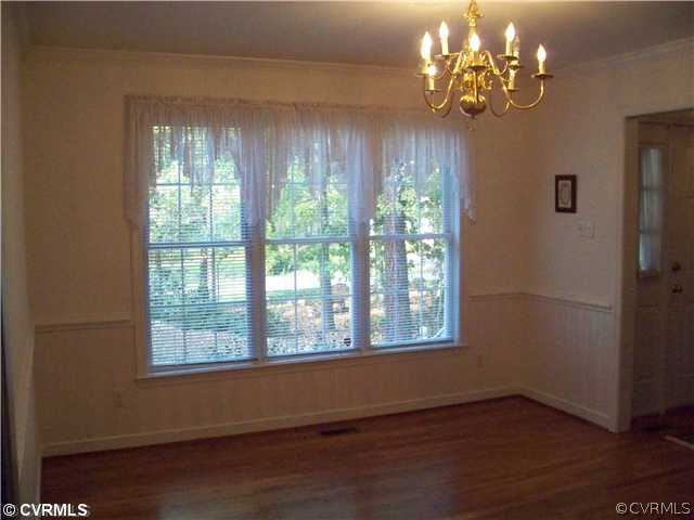 5301 Houndmaster Road Midlothian, VA 23112 - Photo 8 of 12 a view of an empty room with wooden floor and a window