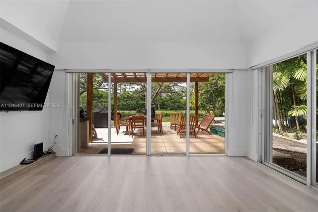 a view of a living room hardwood floor and a flat screen tv