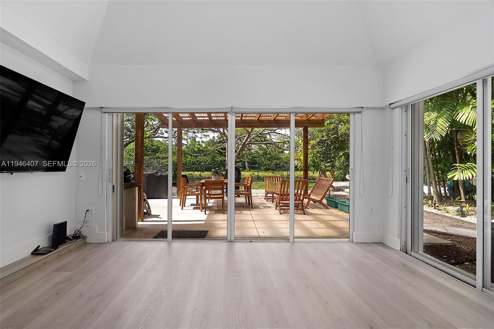 5845 Southwest 88th Street Miami, FL 33156 - Photo 11 of 25 a view of a living room hardwood floor and a flat screen tv