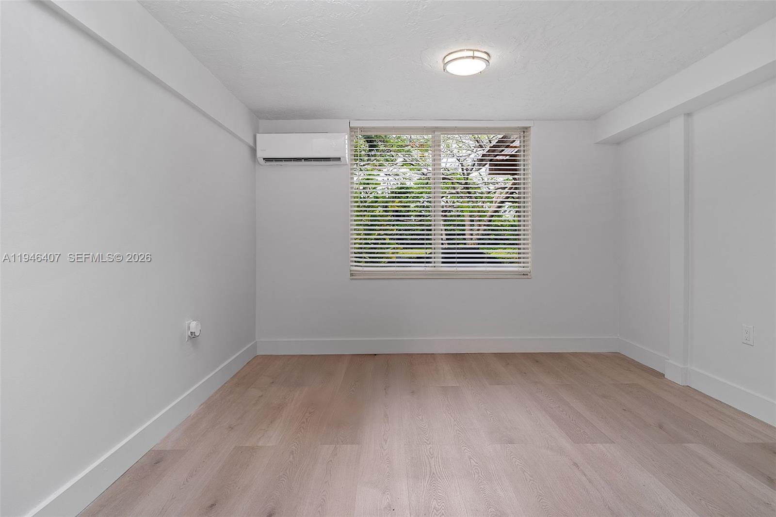 5845 Southwest 88th Street Miami, FL 33156 - Photo 12 of 25 a view of an empty room with wooden floor and a window