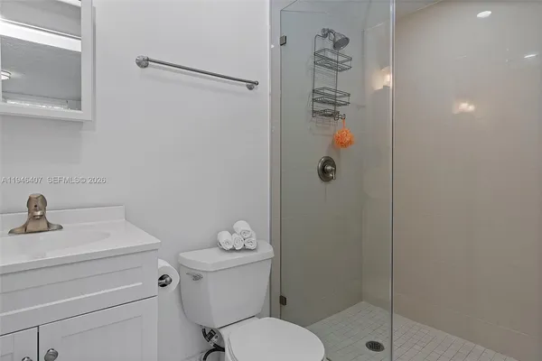 a bathroom with a shower a toilet and sink