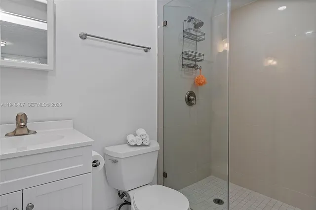 a bathroom with a shower a toilet and sink