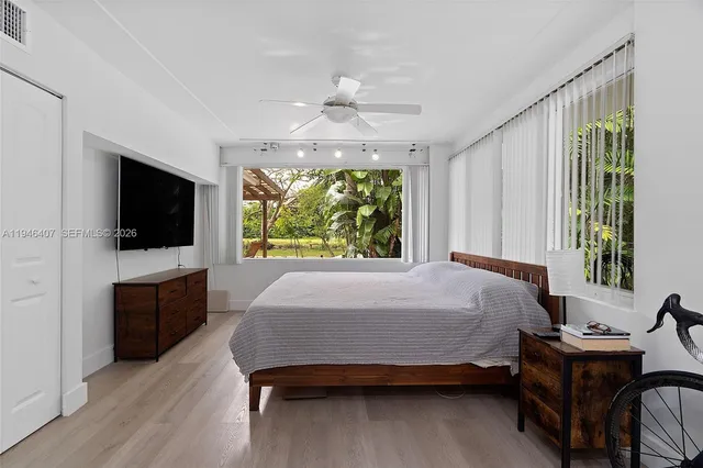 a bed room with a bed and a television