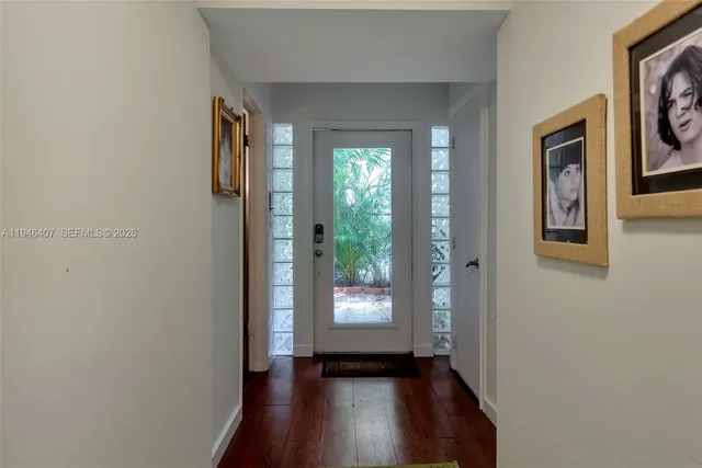 a view of an entryway with wooden floor