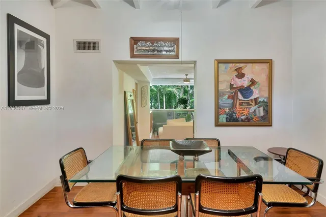 a view of a dining room with furniture and chandelier