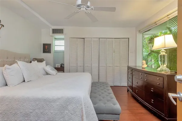 a bedroom with a large bed and a couch