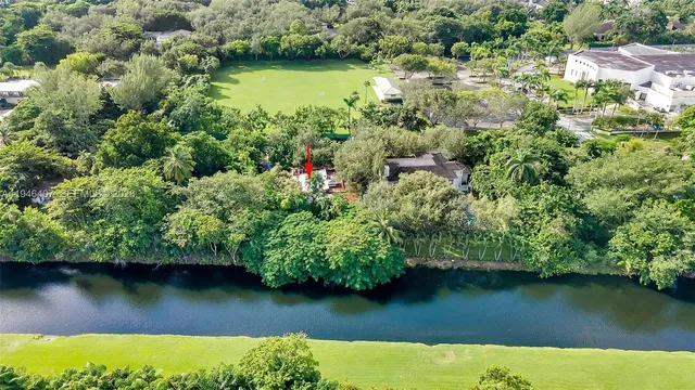 an aerial view of a houses with a yard