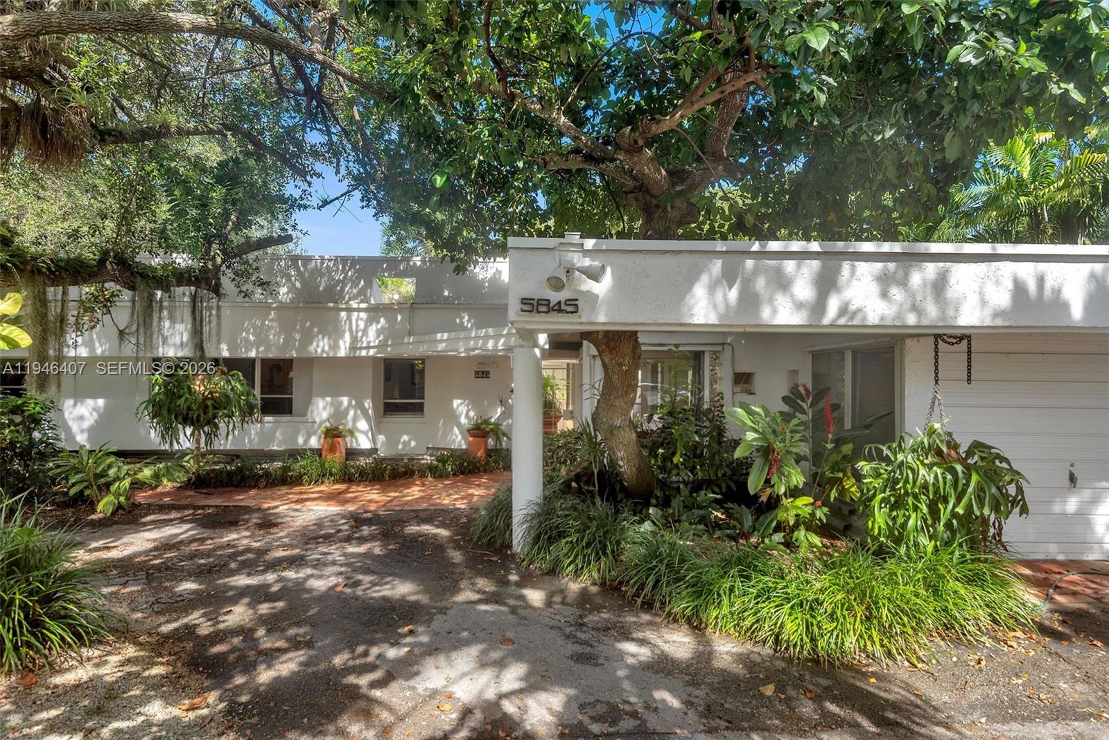 5845 Southwest 88th Street Miami, FL 33156 - Photo 6 of 25 a front view of a house with a yard