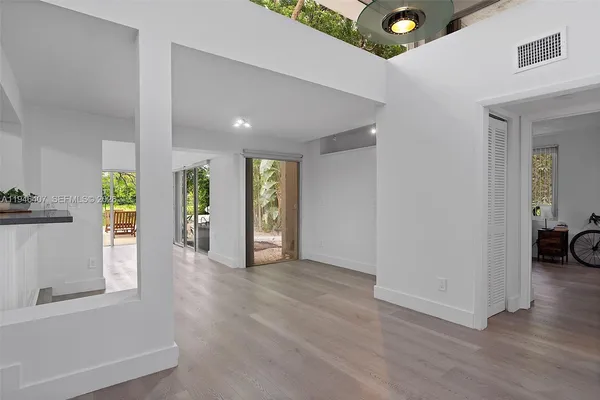 a view of an empty room and a window