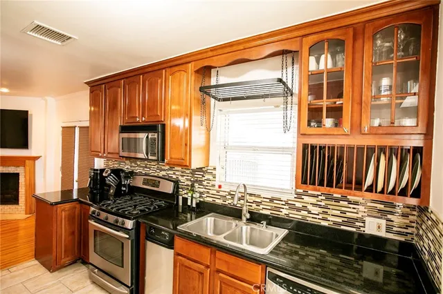 a kitchen that has a sink and a stove