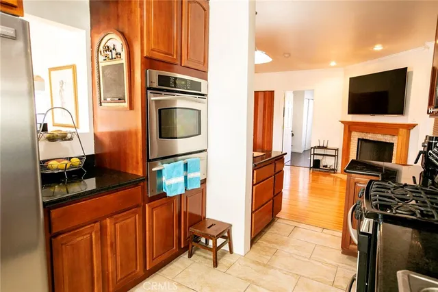 a kitchen with stainless steel appliances granite countertop a stove top oven a sink and dishwasher