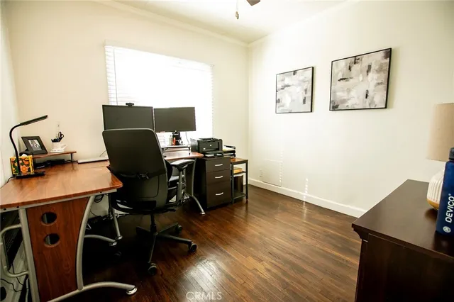 a view of a workspace with furniture and wooden floor