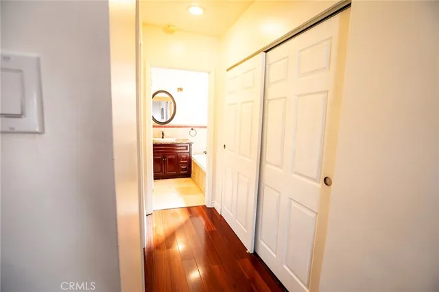 a view of hallway with wooden floor