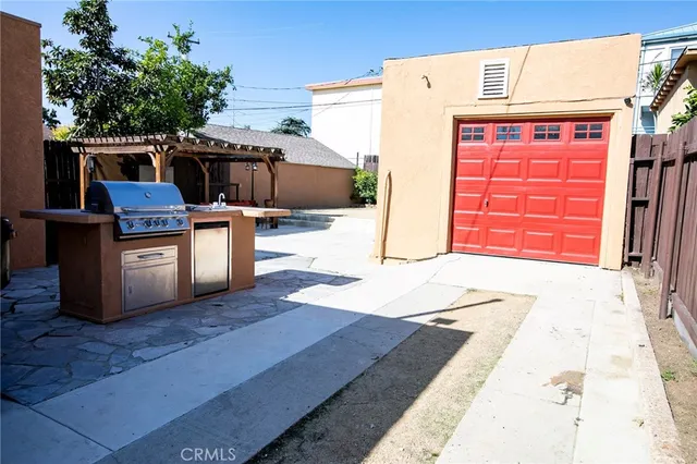 a view of a backyard with barbeque grill and a fireplace