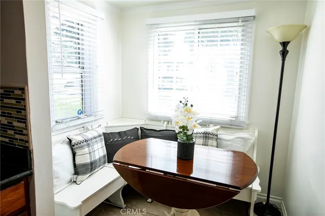 a dining room with furniture and window