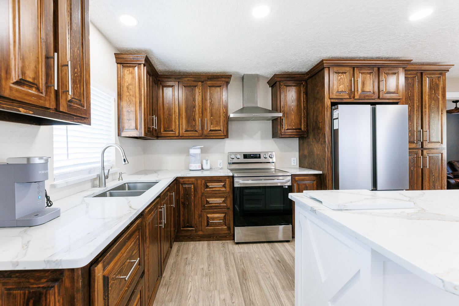 3807 East 3rd Street Lubbock, TX 79403 - Photo 12 of 35 a kitchen with stainless steel appliances a sink stove and refrigerator