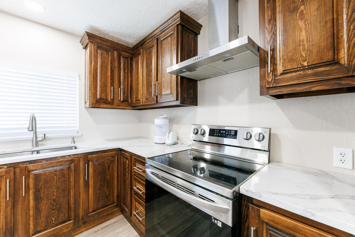 3807 East 3rd Street Lubbock, TX 79403 - Photo 14 of 35 a kitchen with stainless steel appliances granite countertop a sink a stove and a microwave