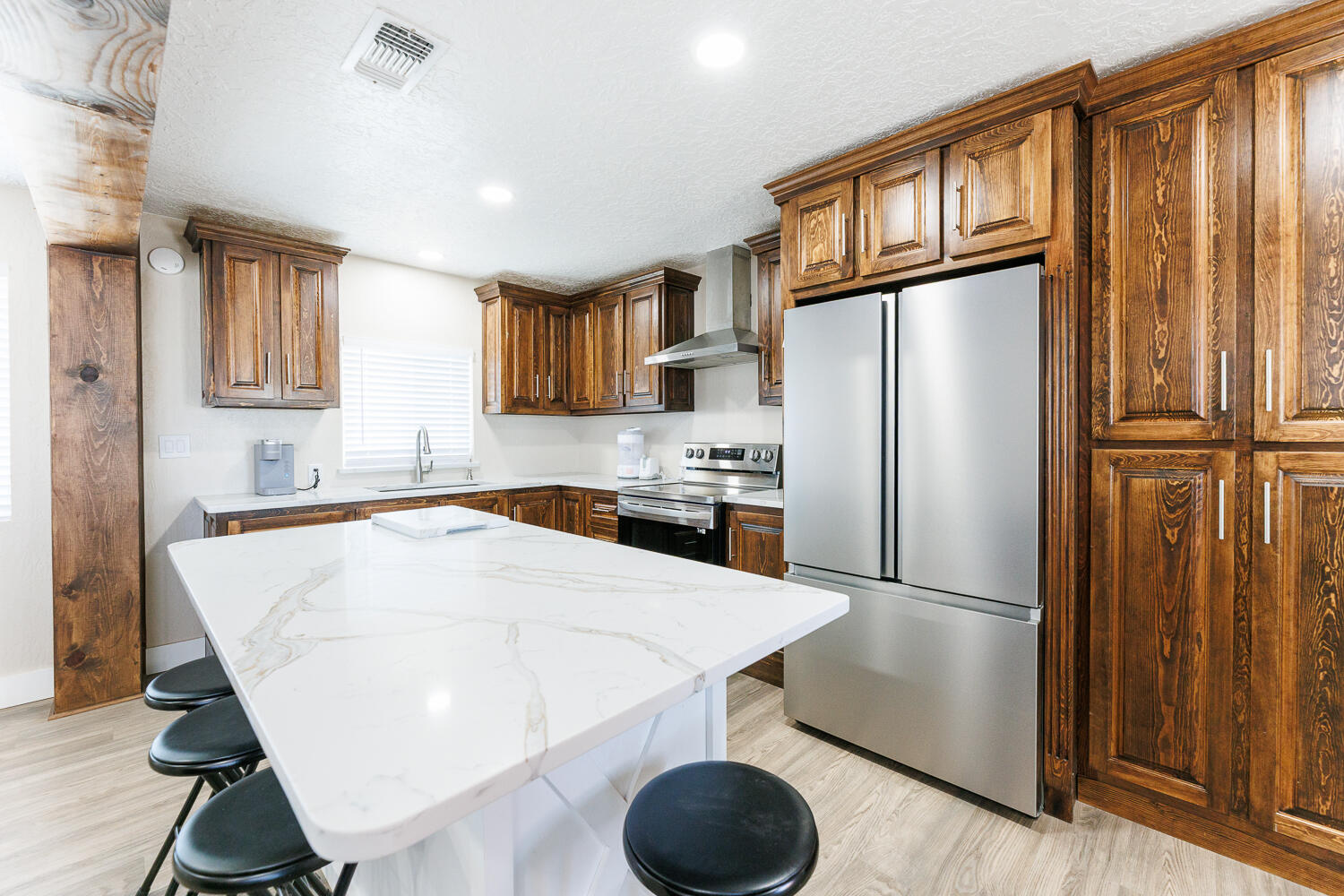 3807 East 3rd Street Lubbock, TX 79403 - Photo 19 of 35 a kitchen with stainless steel appliances a refrigerator and a stove top oven
