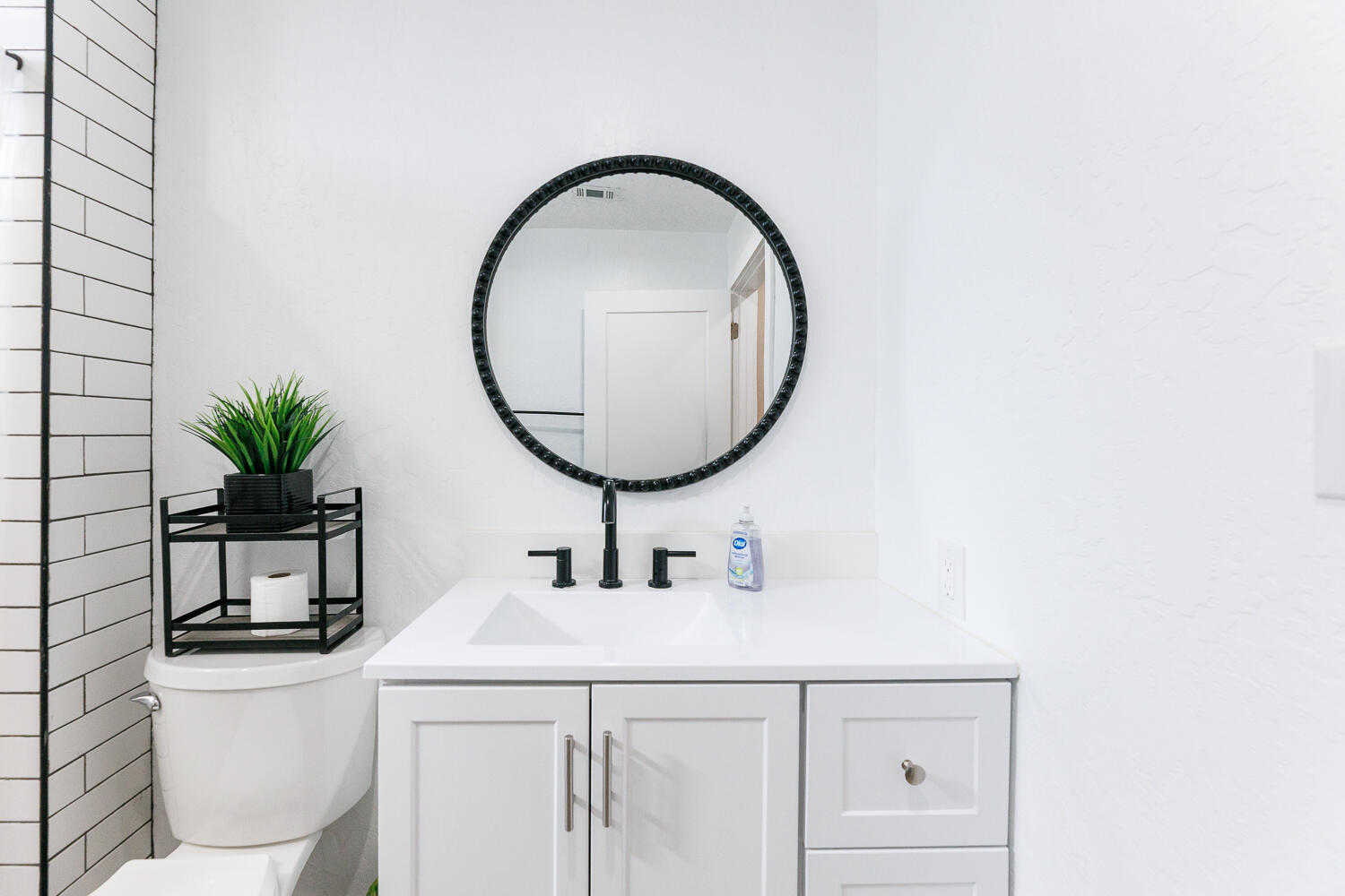 3807 East 3rd Street Lubbock, TX 79403 - Photo 23 of 35 a bathroom with a toilet a sink and a mirror
