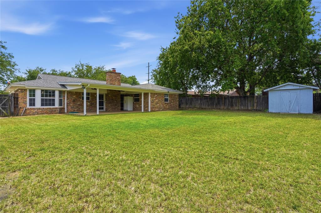 837 Springdale Road Bedford, TX 76021 - Photo 26 of 28 Expansive green lawn with a wood privacy fence