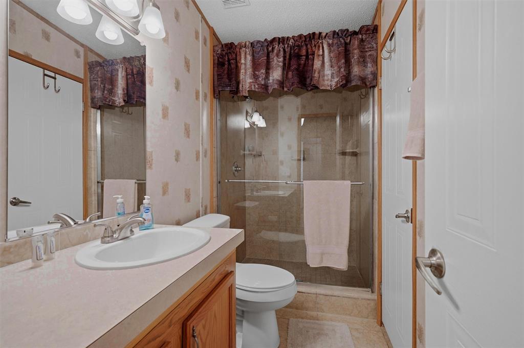 212 Sunset Road Pottsboro, TX 75076 - Photo 20 of 40 a bathroom with a sink a toilet and shower