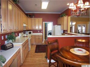 944 Knightsbridge Road Fort Mill, SC 29708 - Photo 5 of 16 a kitchen with stainless steel appliances granite countertop a sink a stove a dining table and chairs
