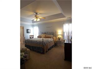 944 Knightsbridge Road Fort Mill, SC 29708 - Photo 8 of 16 a bedroom with a bed and a chandelier