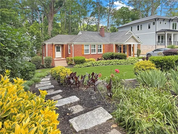 a front view of a house with a garden