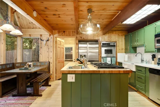 a kitchen with kitchen island granite countertop lots of counter top space and stainless steel appliances