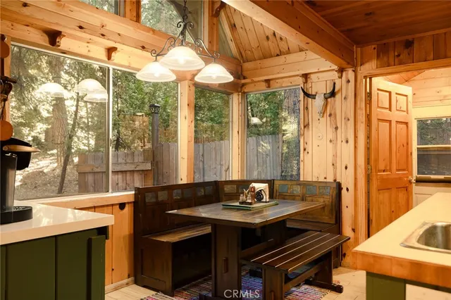 a view of a room with a table and chairs