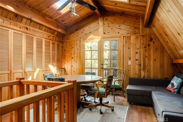 a view of a livingroom with wooden floor and a fireplace