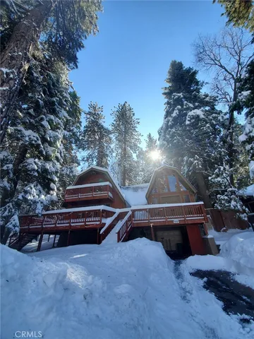 a backyard of a house with wooden fence and trees
