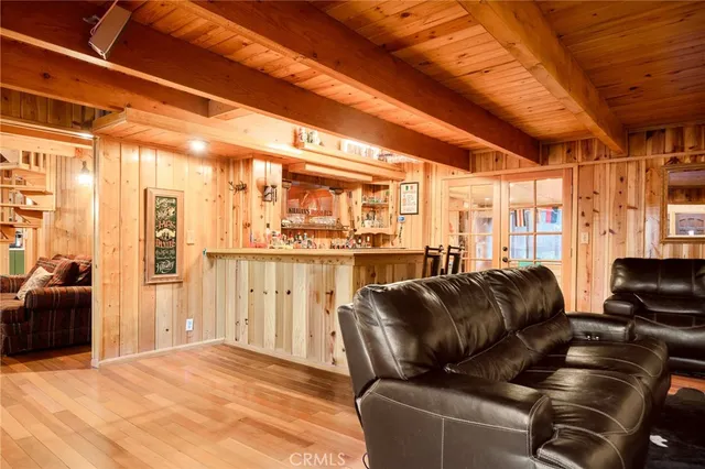 a living room with furniture a large window and chandelier