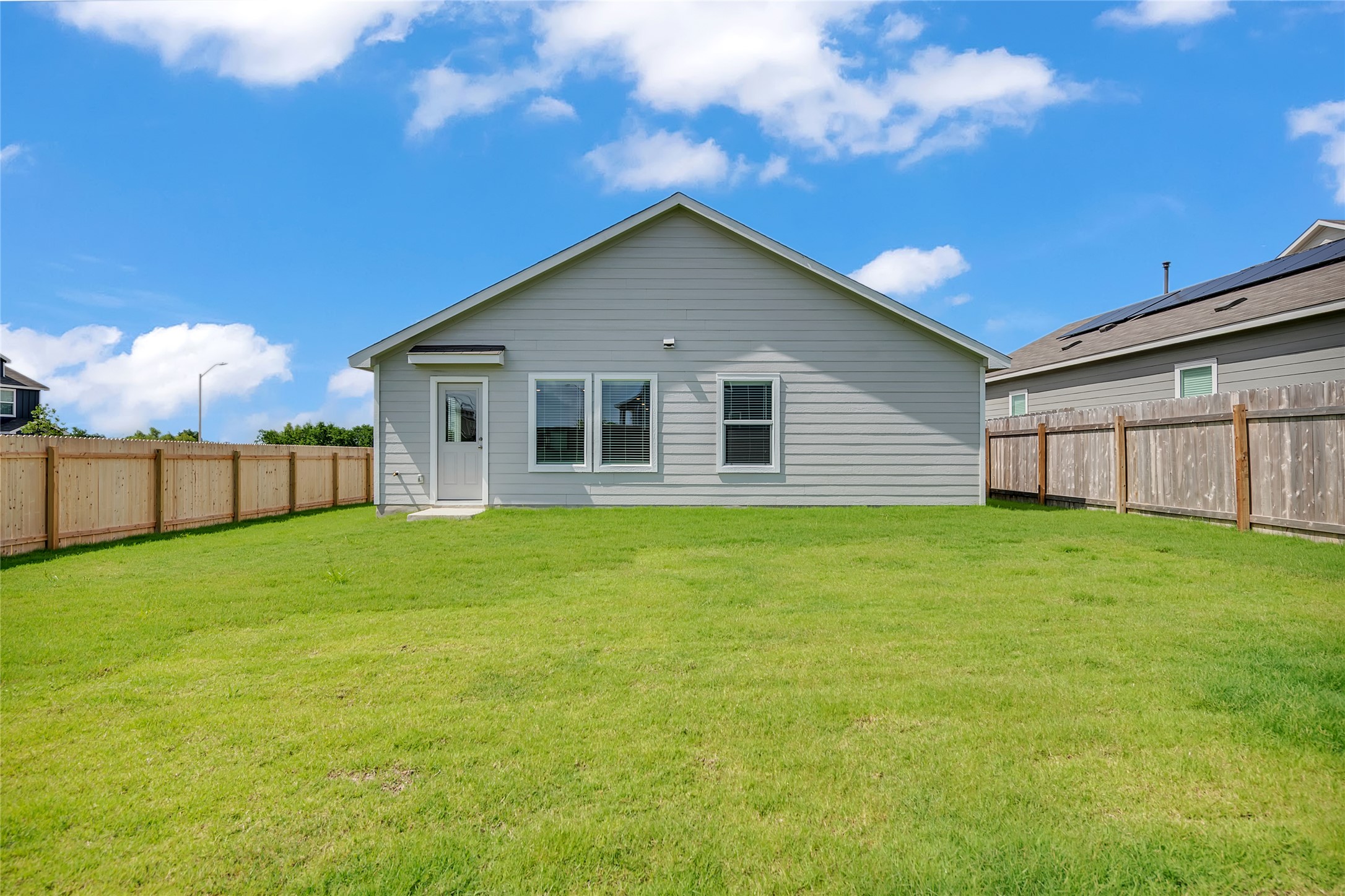 2528 Willkomen Way Manor, TX 78653 - Photo 20 of 21 a view of a backyard with a garden