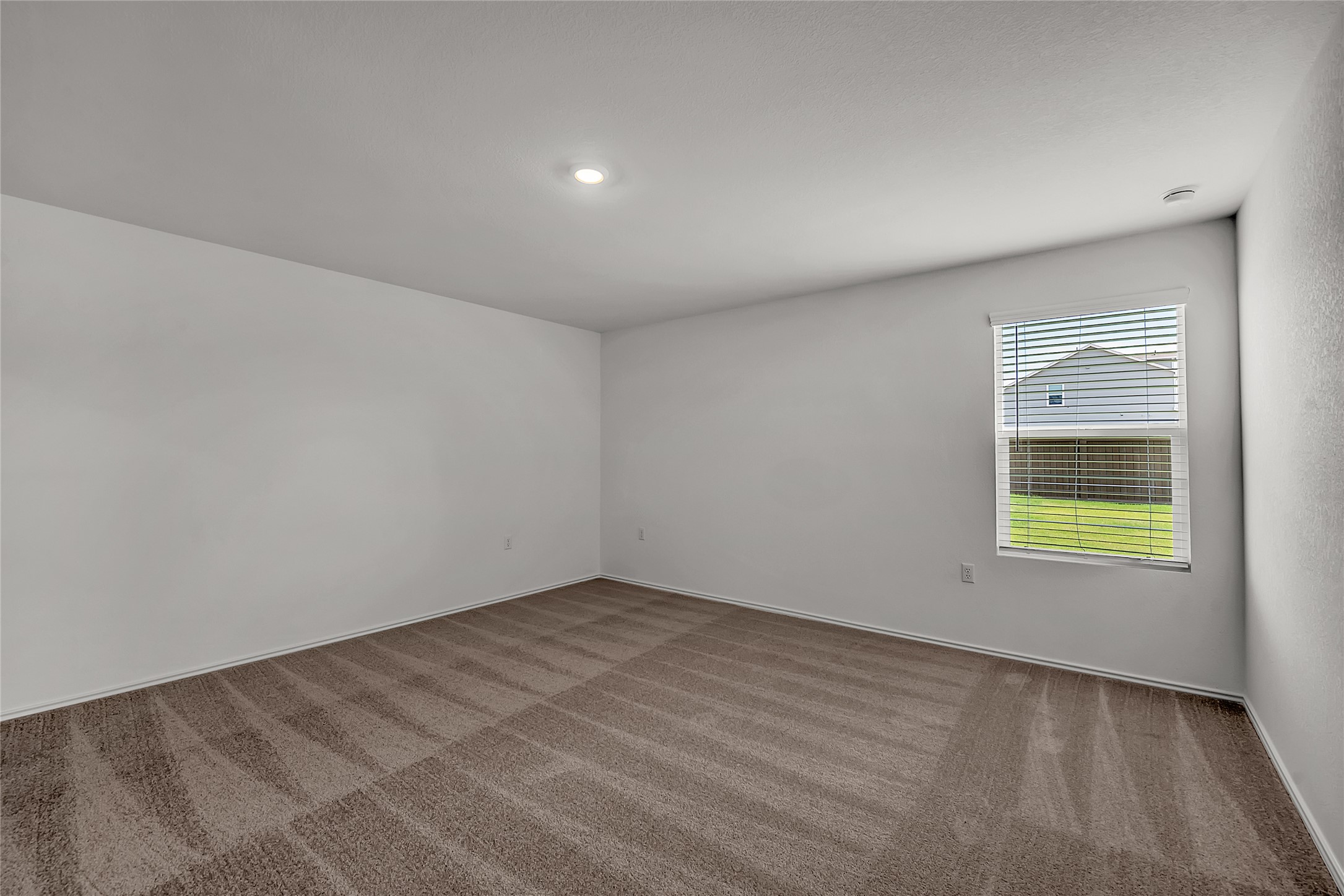 2528 Willkomen Way Manor, TX 78653 - Photo 8 of 21 a view of an empty room and a window
