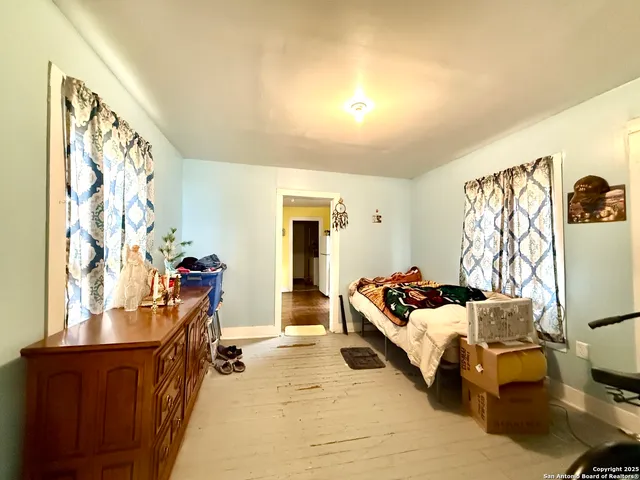 a bedroom with furniture and a window