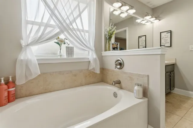 a spacious bedroom with two beds and a window