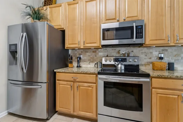 a view of a dining room with furniture and a chandelier
