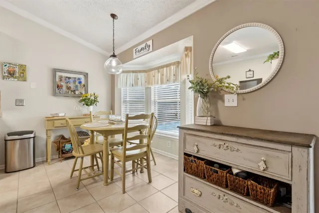 a kitchen with cabinets and chairs