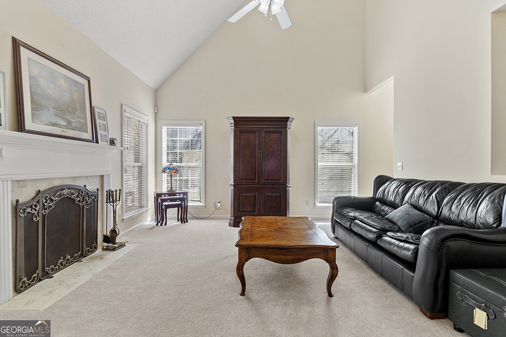643 Millrun Court Macon, GA 31210 - Photo 13 of 32 a living room with furniture a fireplace and a flat screen tv