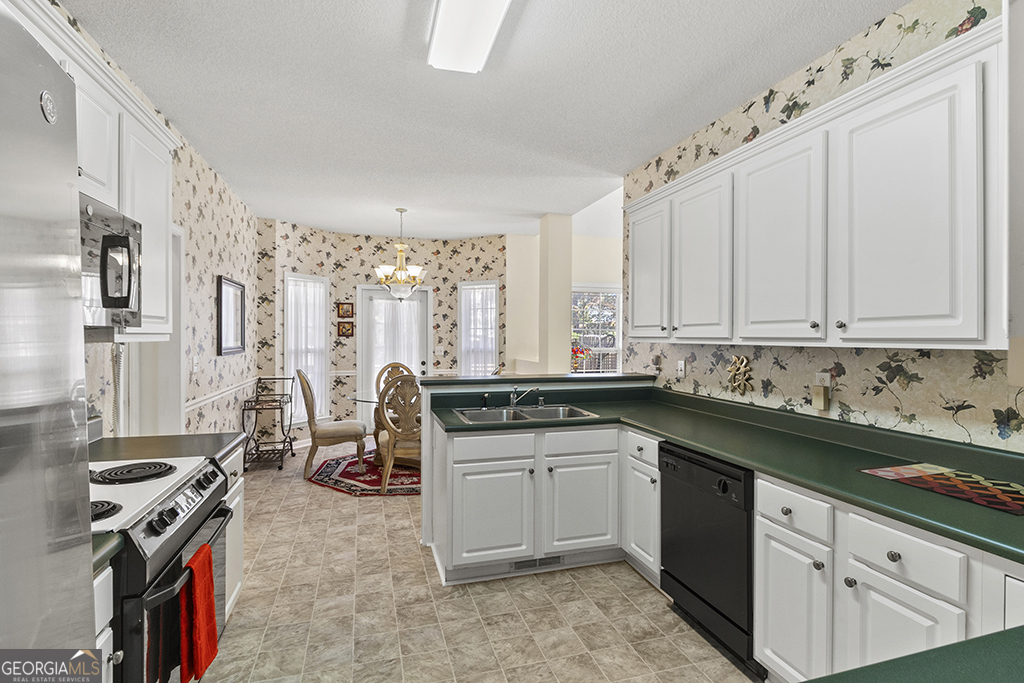 643 Millrun Court Macon, GA 31210 - Photo 14 of 32 a kitchen with stainless steel appliances a sink stove and cabinets